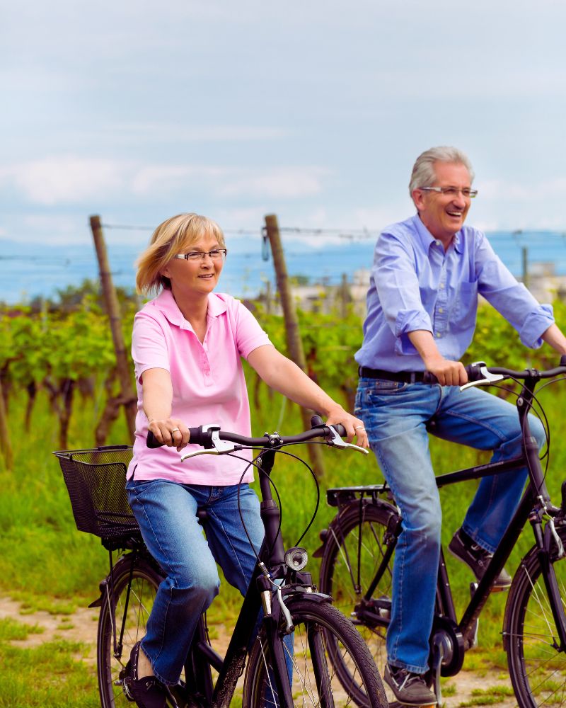 a man and woman riding bicycles after discovering hobbies for couples over 50