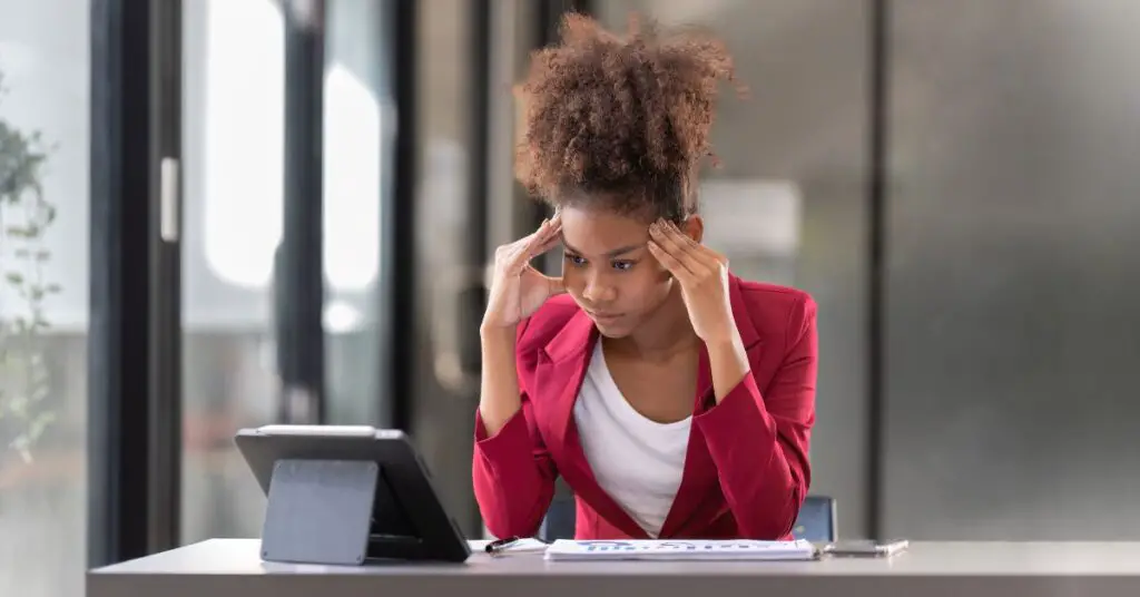 Frustrated woman working on a computer learning WordPres