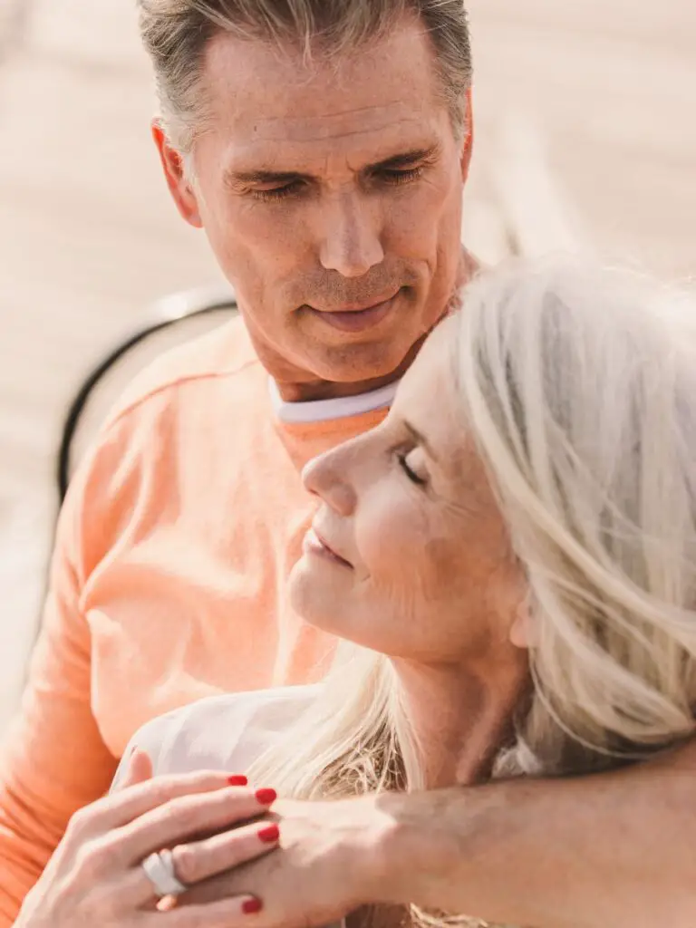 A man and woman sitting together after responding to a dating profile for females over 50.