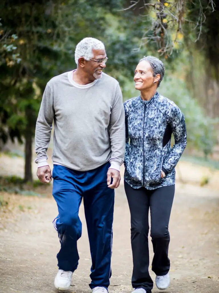 A man and woman walking on a path during a date after using examples of dating profiles for females over 50.