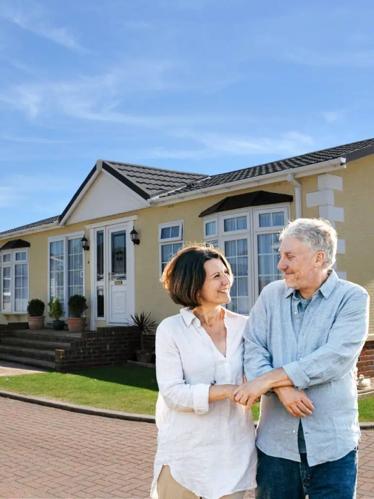 a man and woman standing in front of a mobile home park for people over 50.