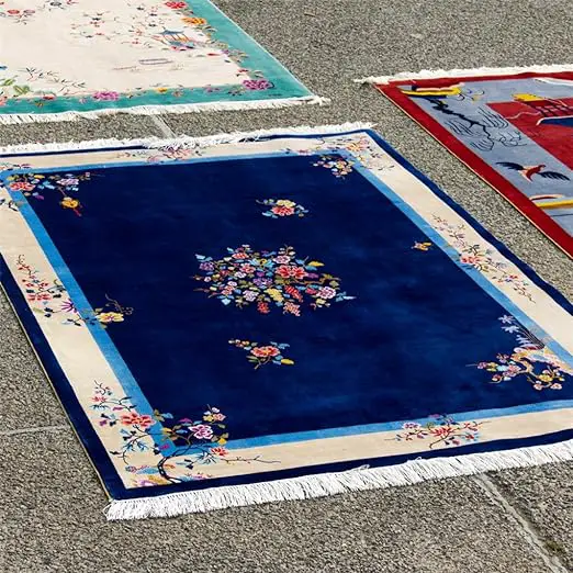 A group of rugs on the ground that are all more affordable than the most expensive rug.