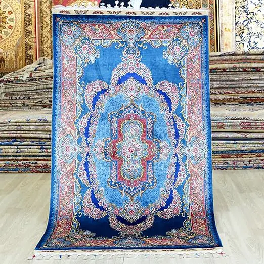 A blue silk rug with a pattern on it that is more affordable than the most expensive rug in the world.