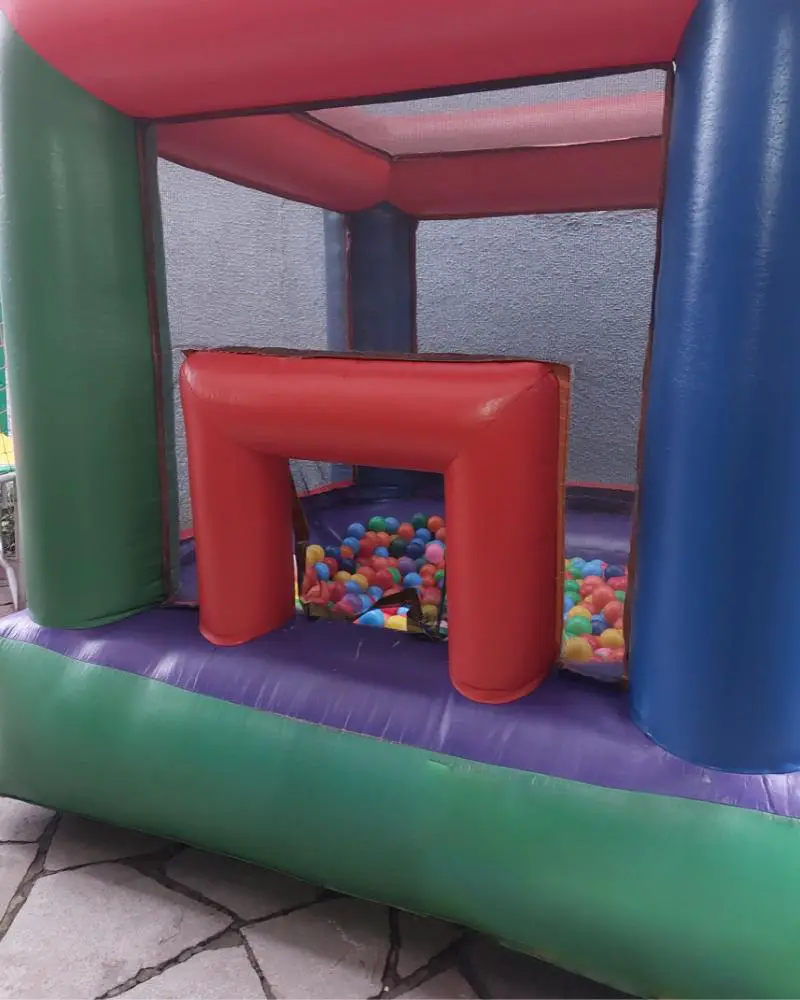 An inflatable bounce house with balls inside that someone is renting out as part of their side-hustle for people over 50.