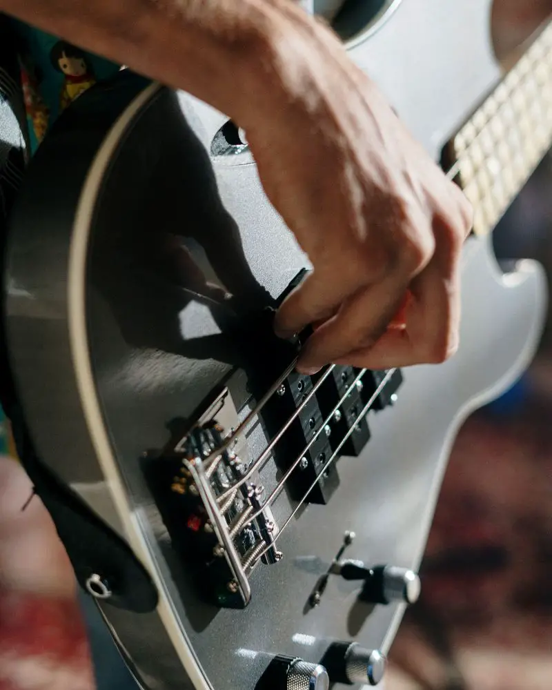 a person playing a guitar to demonstrate one of many hobbies for men over 60