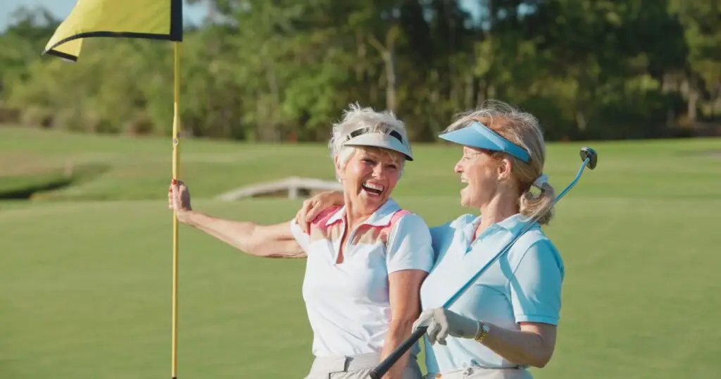 Two people having fun playing golf while showing off their women's golf attire etiquette.