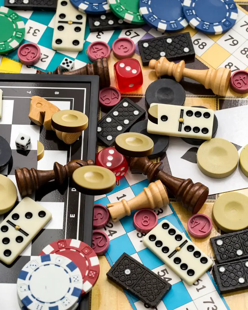 a group of game pieces and dice to demonstrate one of many hobbies for men over 60