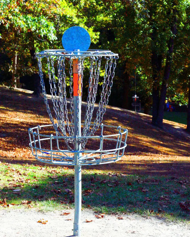 a metal object with chains on it used in the game of disc golf, which is a great hobby for men-over-60