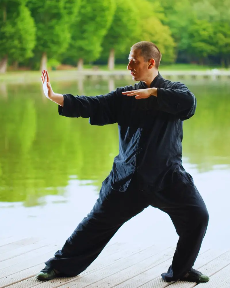 a man in black clothes doing tai chi to demonstrate the many hobbies for men over 60