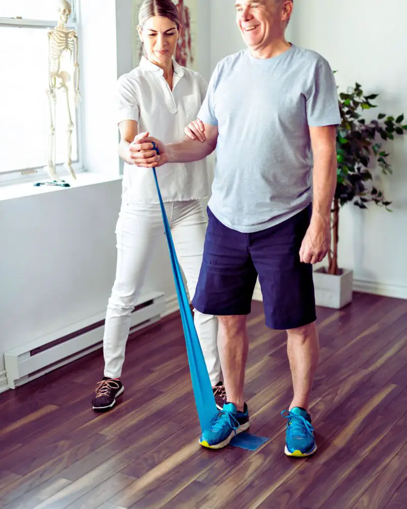 a man and woman exercising with a rubber band demonstrating interesting facts about physical therapy
