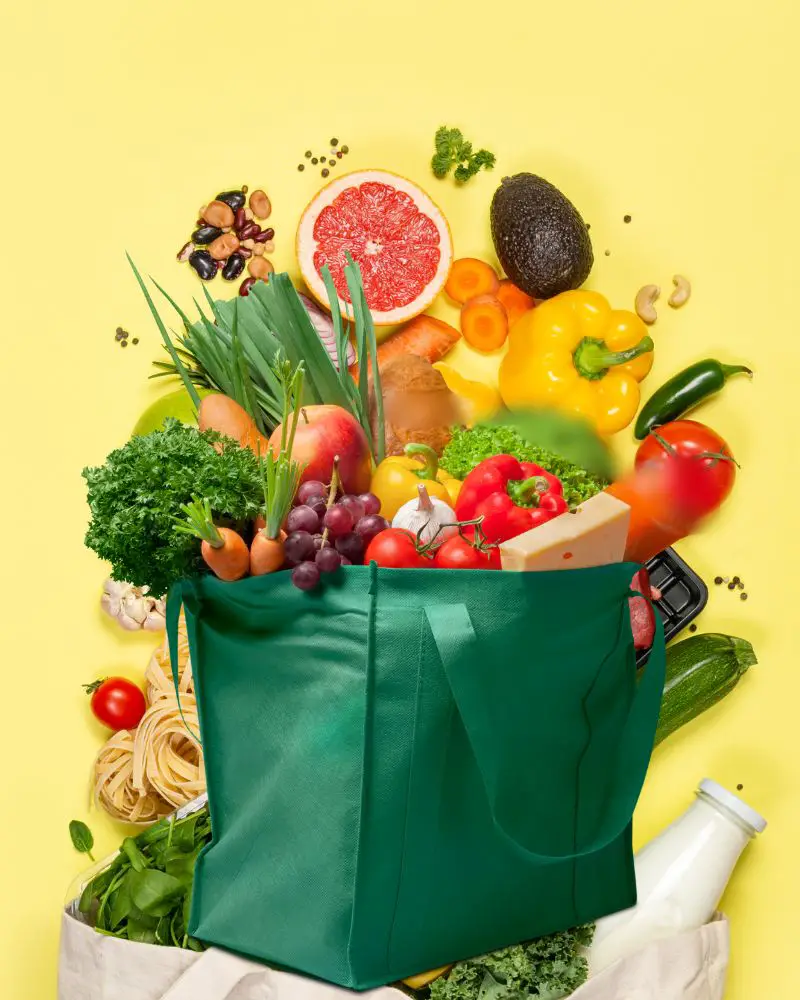 A green bag full of produce to show the benefits of Amazon prime for seniors, including Amazon Fresh