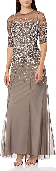 a long, three-quarter sleeved ball down with silver sparkles in a neutral color is one option if deciding what to wear to a wedding over 50