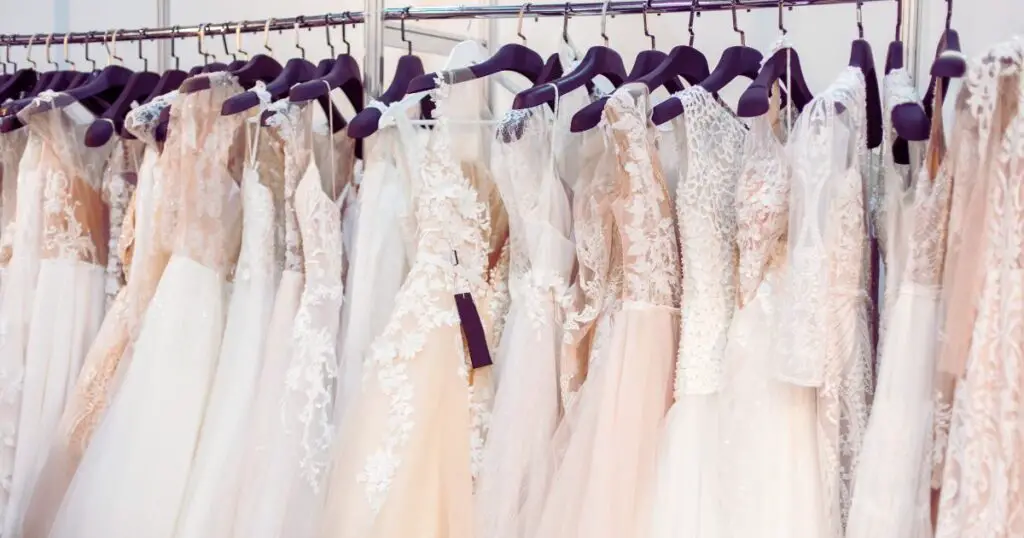 a group of dresses on hangars to represent a variety of second marriage wedding dresses for women over 50