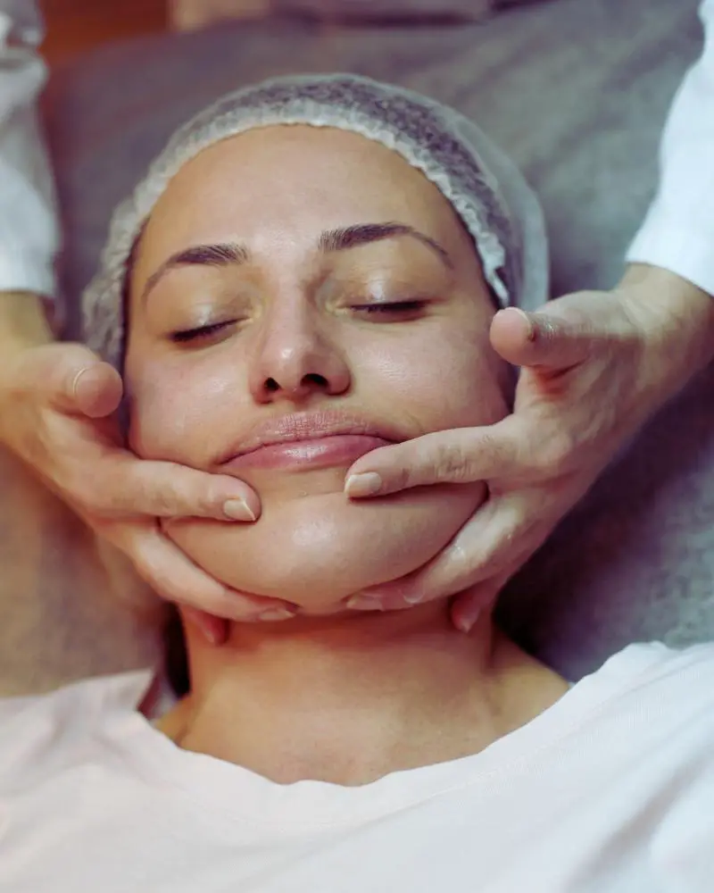 woman getting a facial massage although you should not get a massage after botox