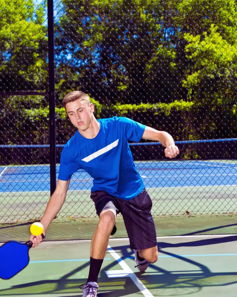 a man playing pickleball while being mindful of pickleball etiquette