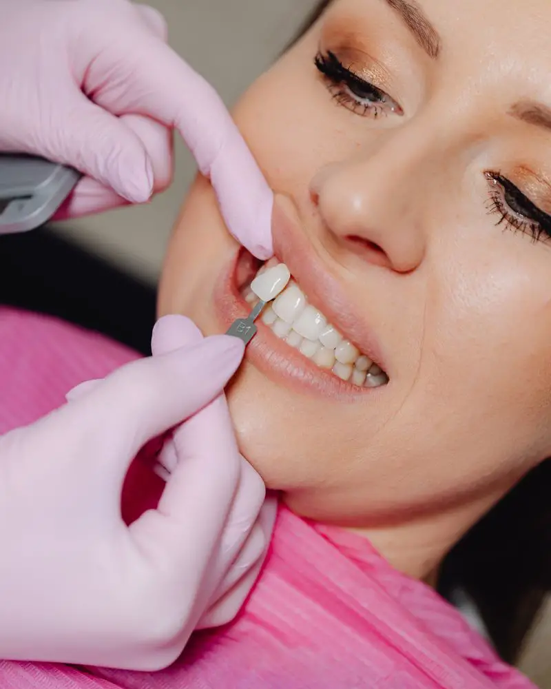 a woman getting her teeth checked to see if she is a candidate and whether dental veneers are bad for your teeth.