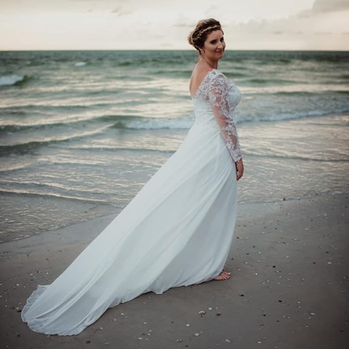 Woman on the beach wearing a white wedding dress with a long train