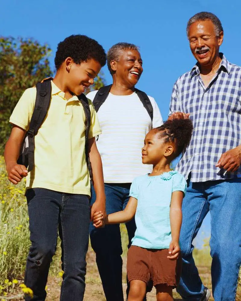 Grandparents out for a walk talking about how to say no to watching the grandkids 