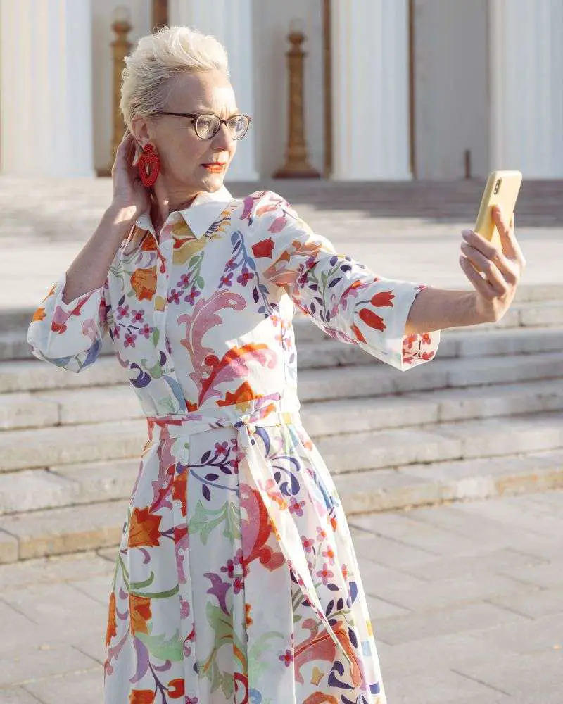 a woman taking a selfie after using the advice given to her by beauty bloggers over 50