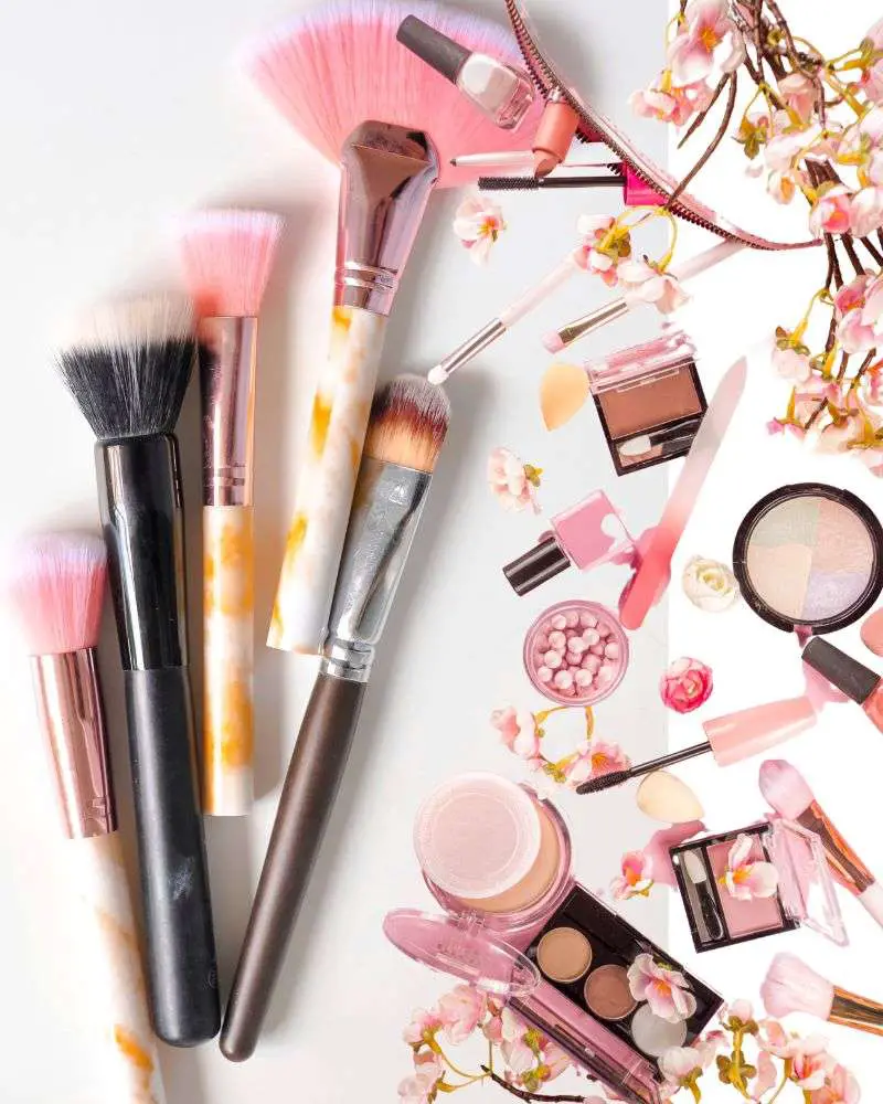 a group of makeup brushes and blush