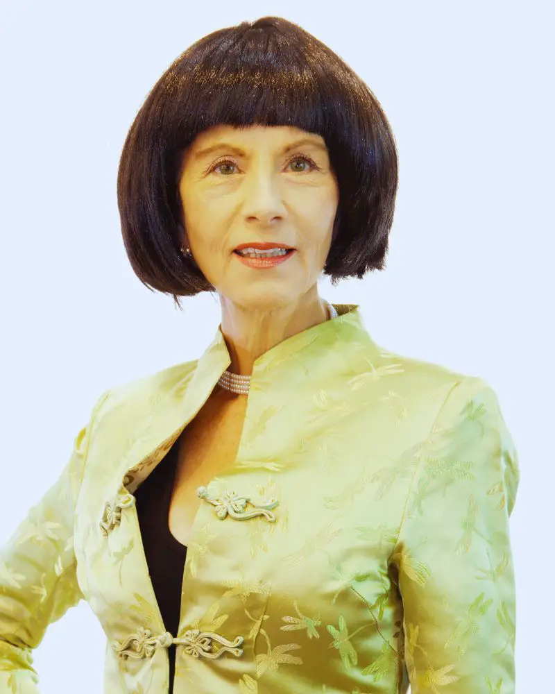 Over 50 model with a short brown bob and a lime green jacket