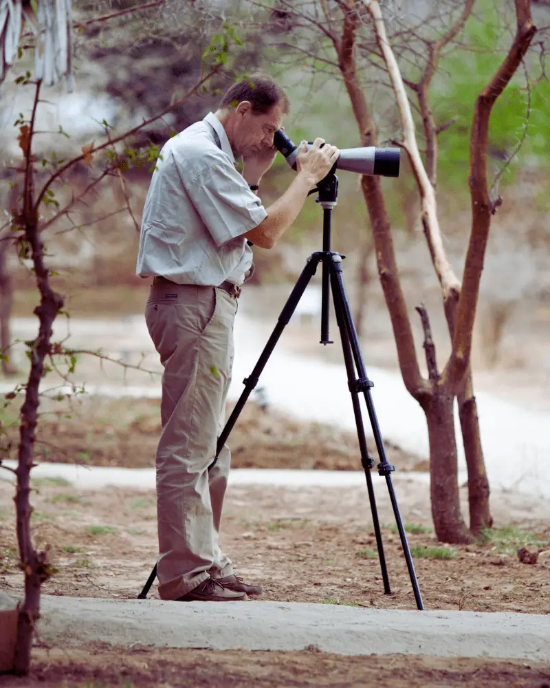 a man looking through a telescope