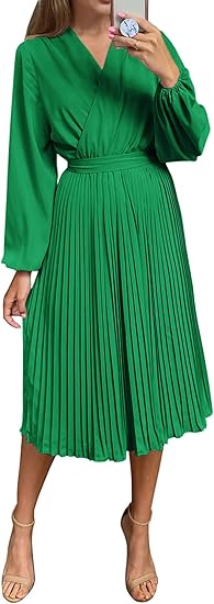 Woman modelling a green mid length dress to show what to wear to a wedding over 50