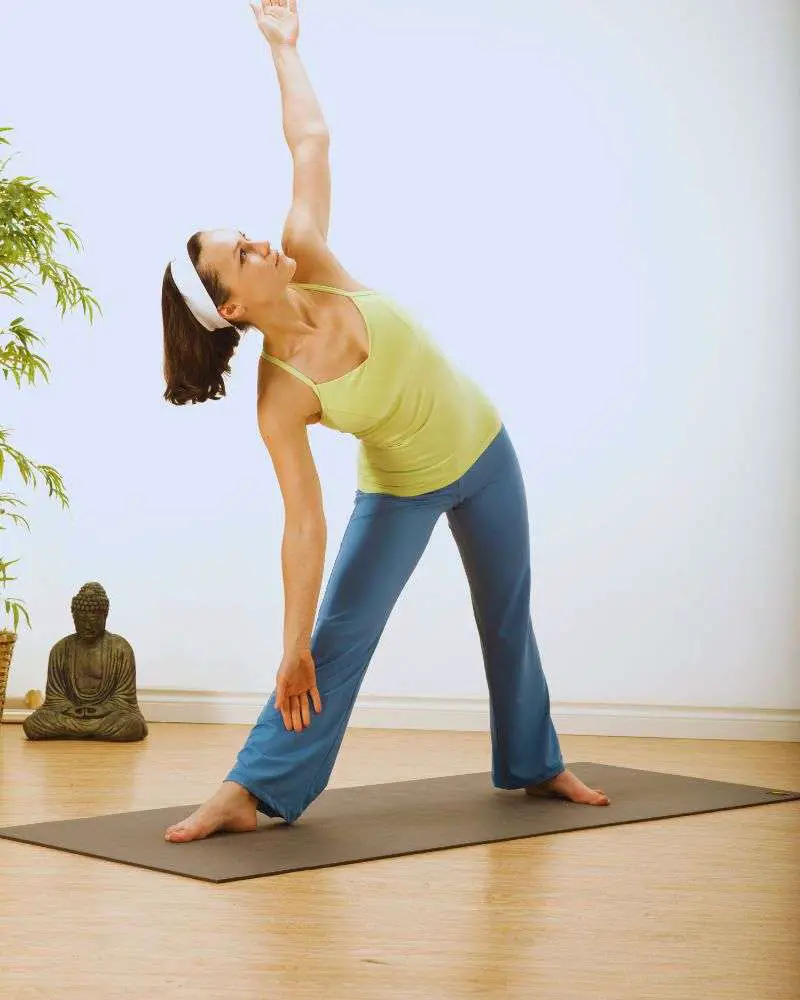 a woman stretching on a mat to demonstrate how yoga for couples over 50 is accessible