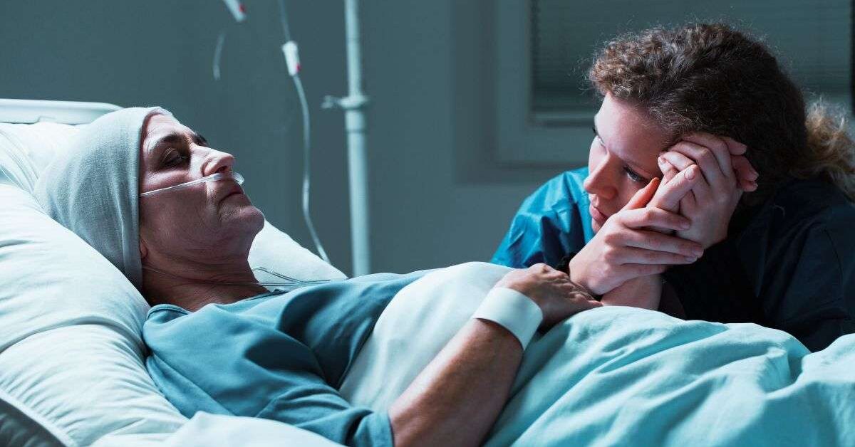 A caregiver sitting at a dying patient's bedside wondering how long do hospice patients live without eating?