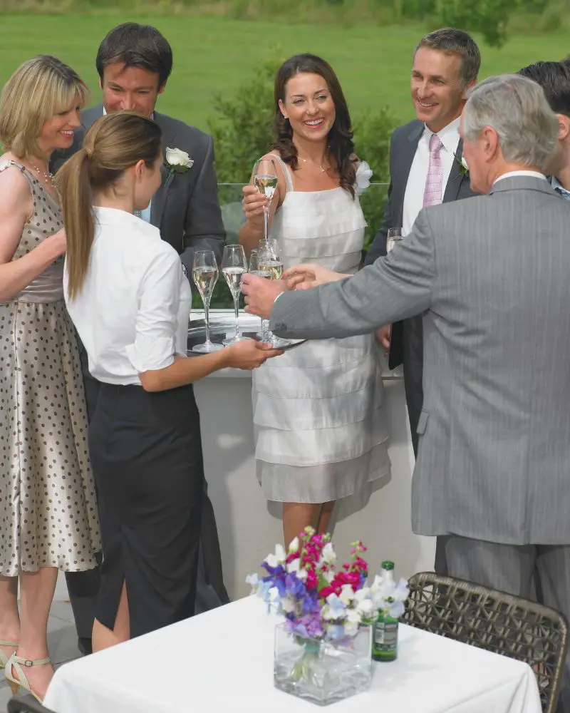 a group of people standing around a table