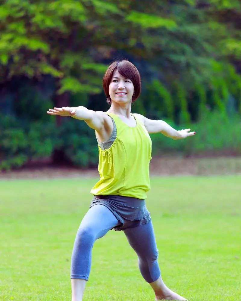 a woman standing in a pose with her arms out