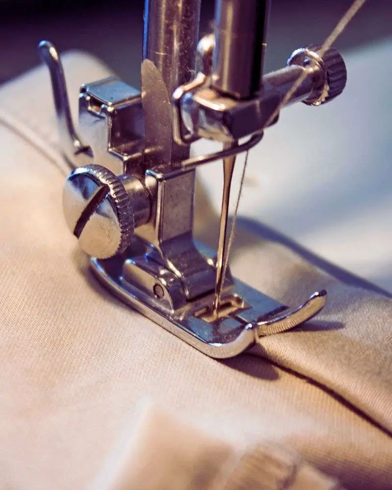 a sewing machine with a needle, often depicted in 19-best-sewing-blogs-for-over-50