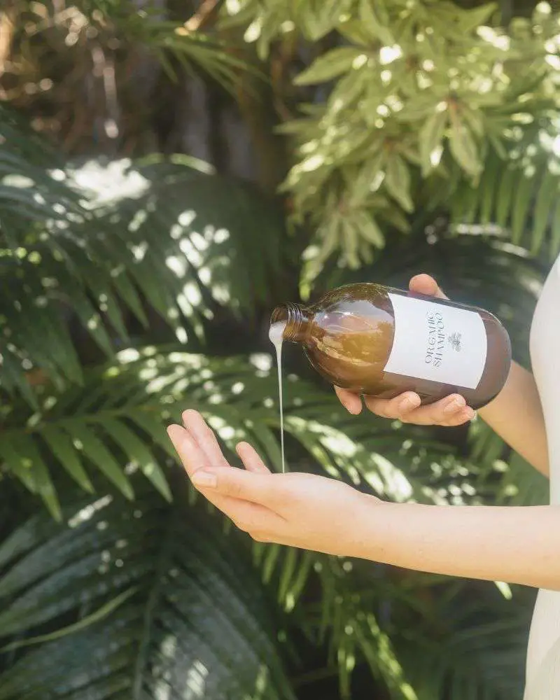 A bottle of shampoo being poured into a hand to demonstrate the best-shampoo-and-conditioner-for-hair-over-50