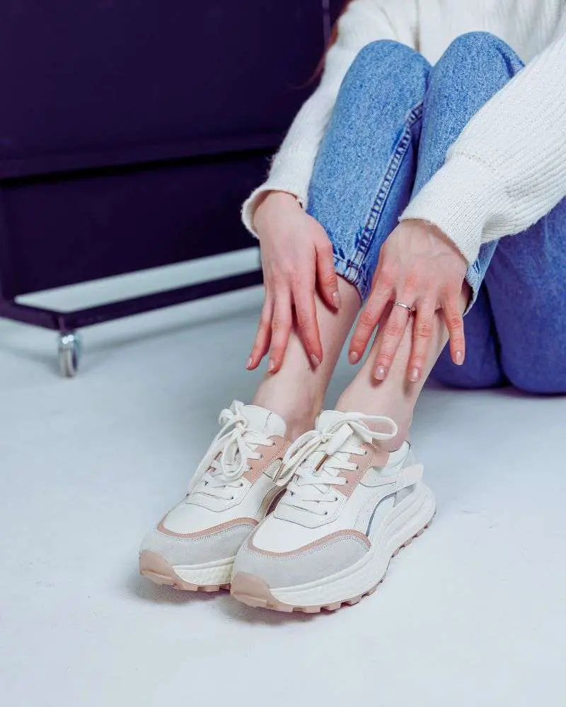 Woman wearing blue jeans and arch support sneakers for women over 50