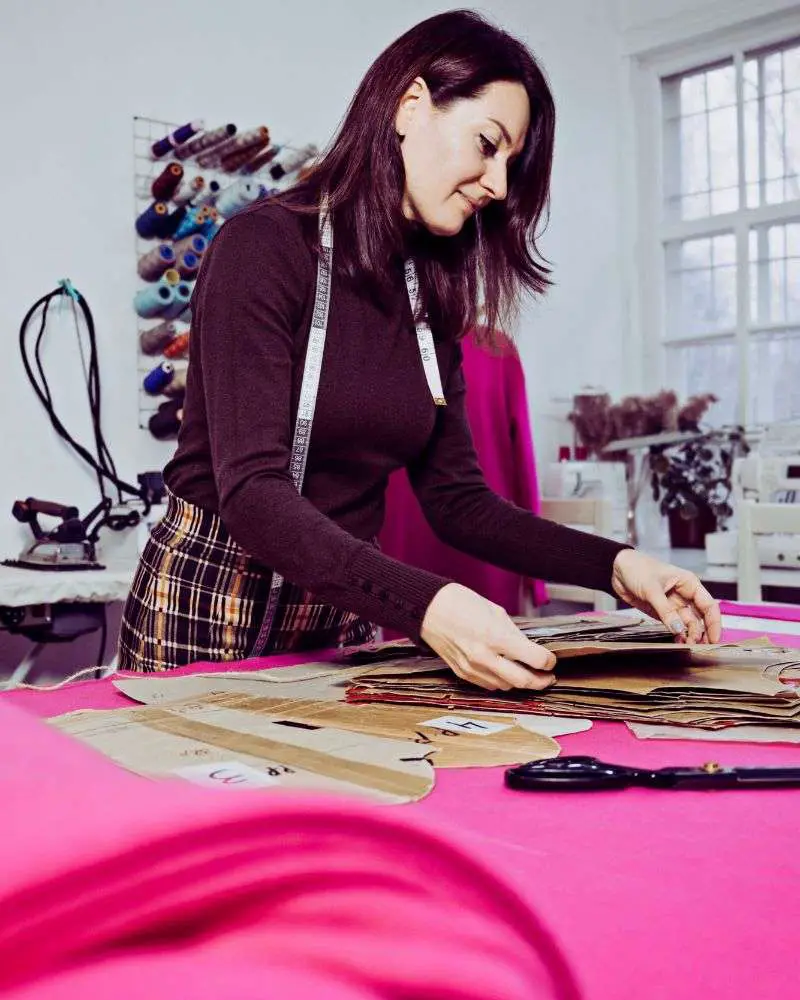 a woman working on a sewing project after reading 19-best-sewing-blogs-for-over-50