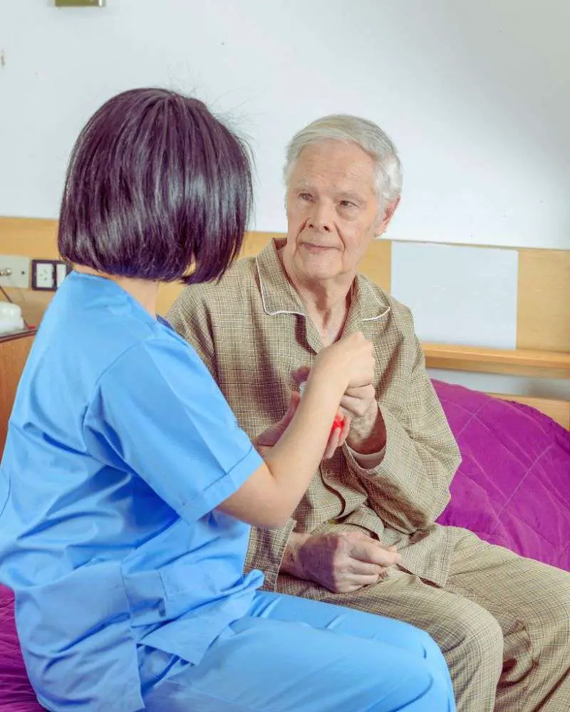 A nurse trying to feed finger foods for the elderly