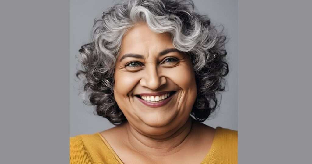 a smiling woman with short, curly, silver hair to demonstrate various hairstyles for over 50 and overweight