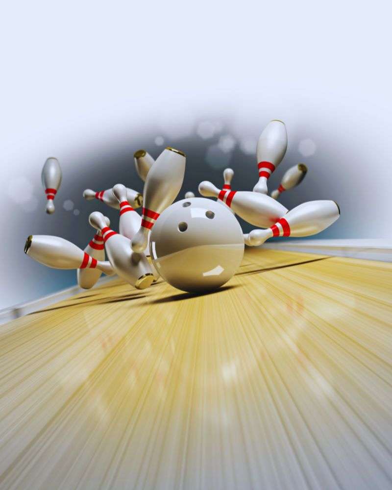 White bowling ball knocking over all the bowling balls