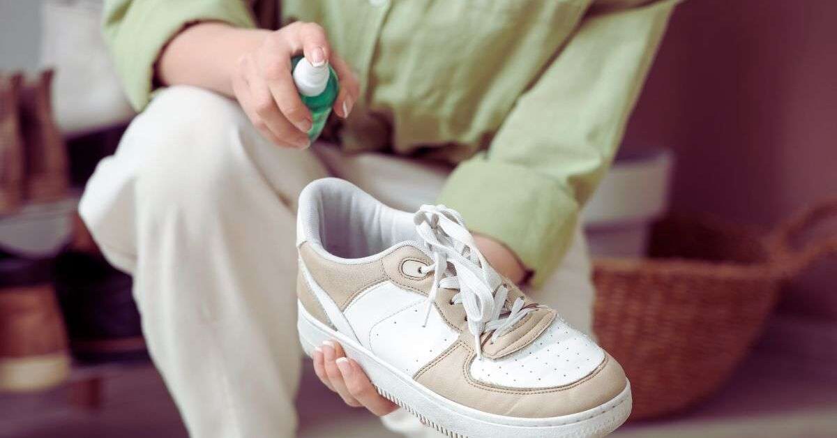 Woman holding a sneaker that is designed as arch support sneakers for women over 50