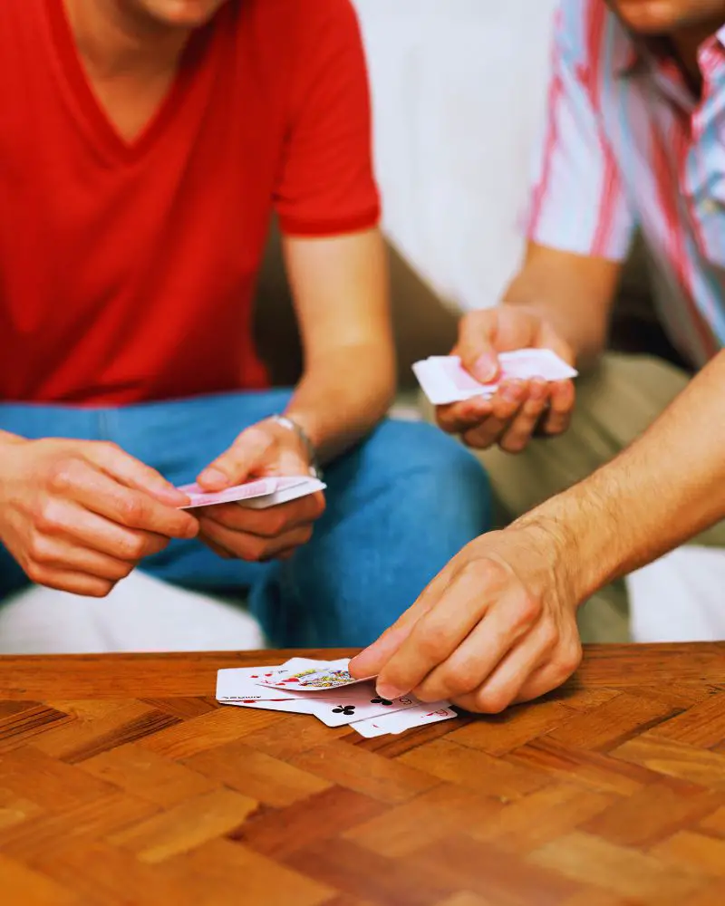 Two people who learned how to create their own memory games and are playing cards.