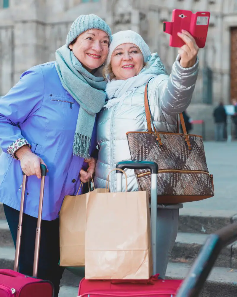 two women learning how to take a good selfie over 50