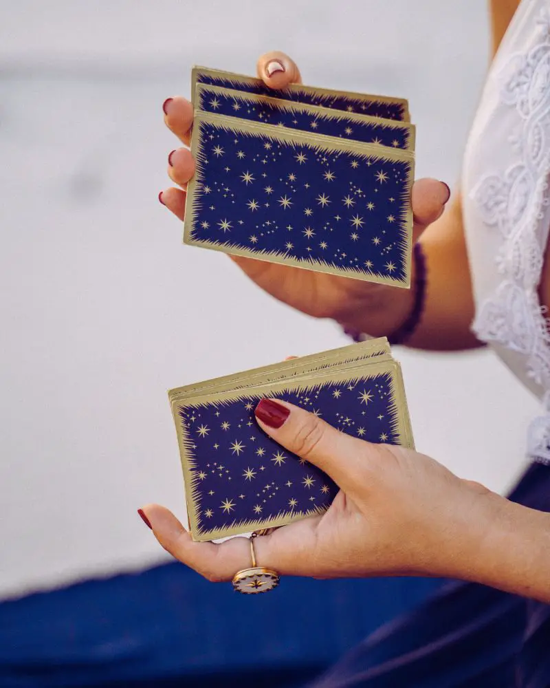 A woman shuffling a deck of cards after learning how to create your own memory games