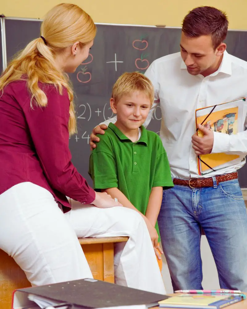 a man and woman standing next to a boy after considering foster-parenting-over-50