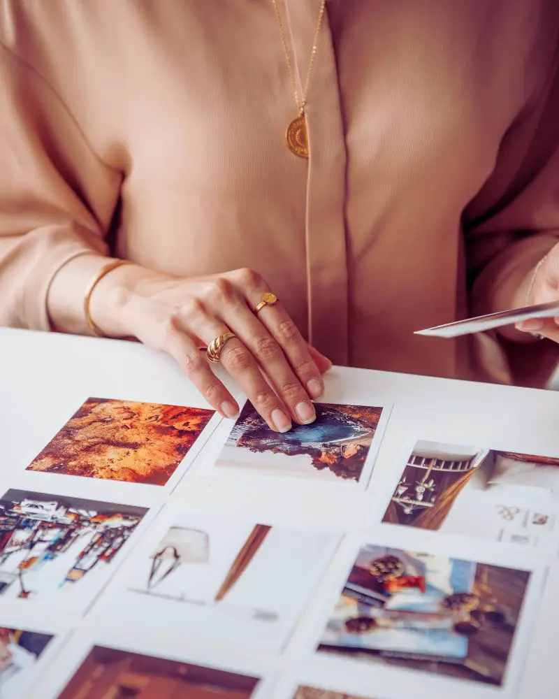 A woman looking through a photo album after learning how to make your own memory games 