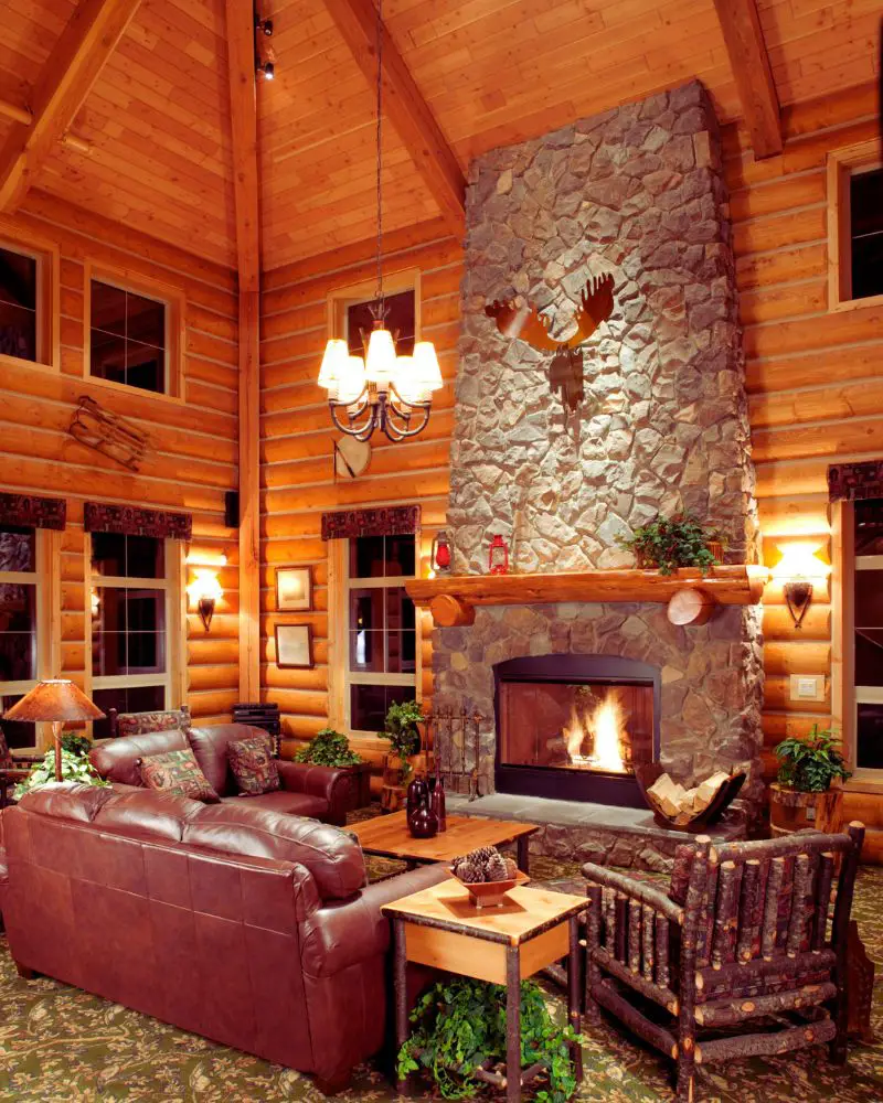 a room with a fireplace and couches to convey cabin quotes for instagram