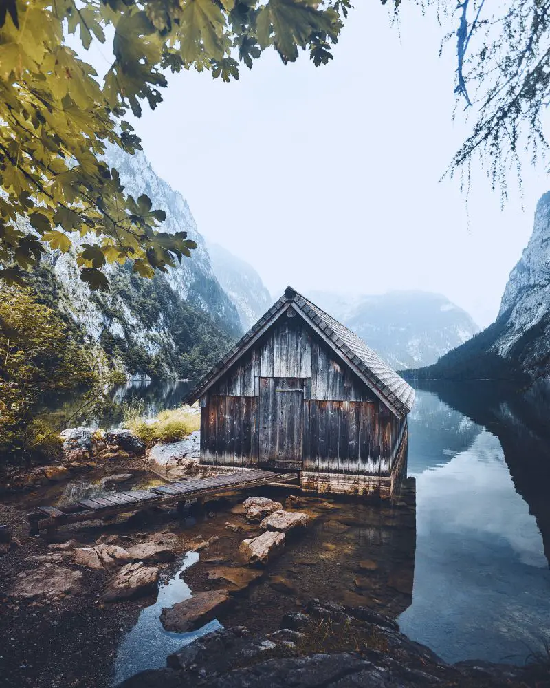 a photo of a wooden cabin on a lake to help describe cabin quotes for instagram