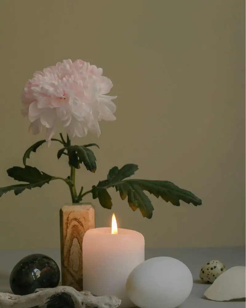 aromatherapy candles next to a flower to demonstrate great Christmas gift ideas for wife over 50