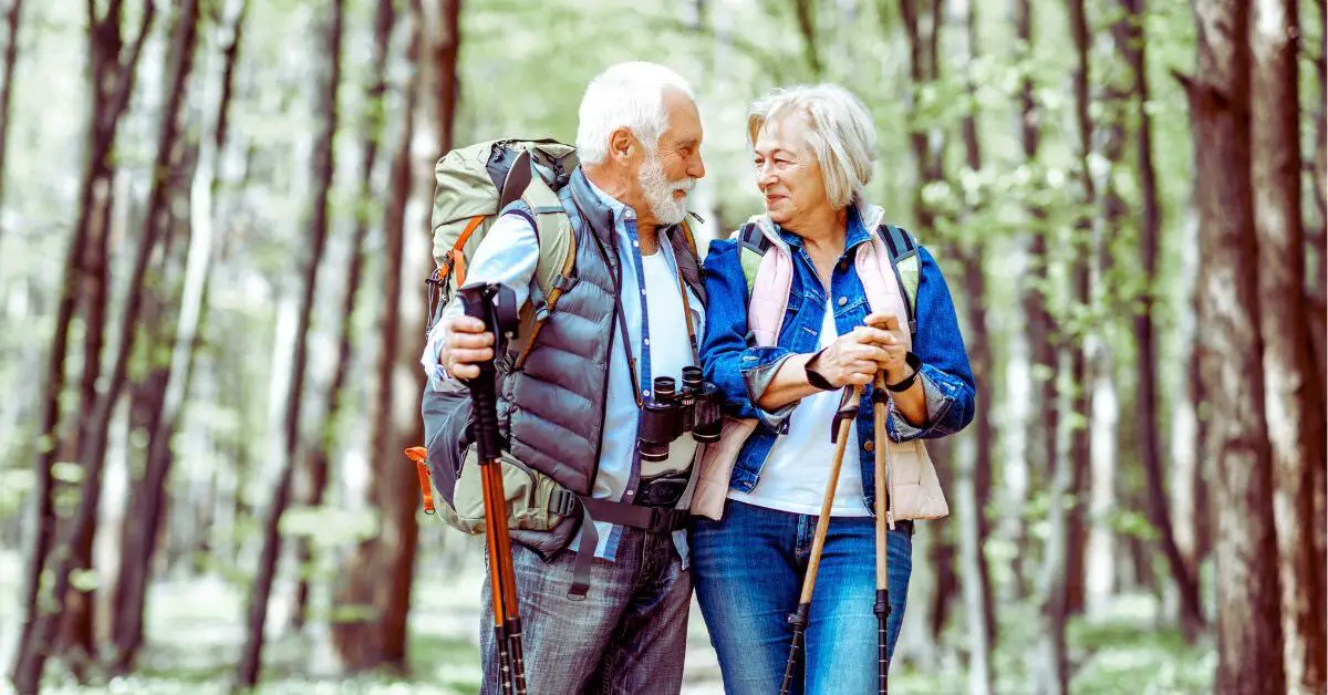 a man and woman with backpacks and hiking poles on a date after learning how to overcome nerves on a first date over 50