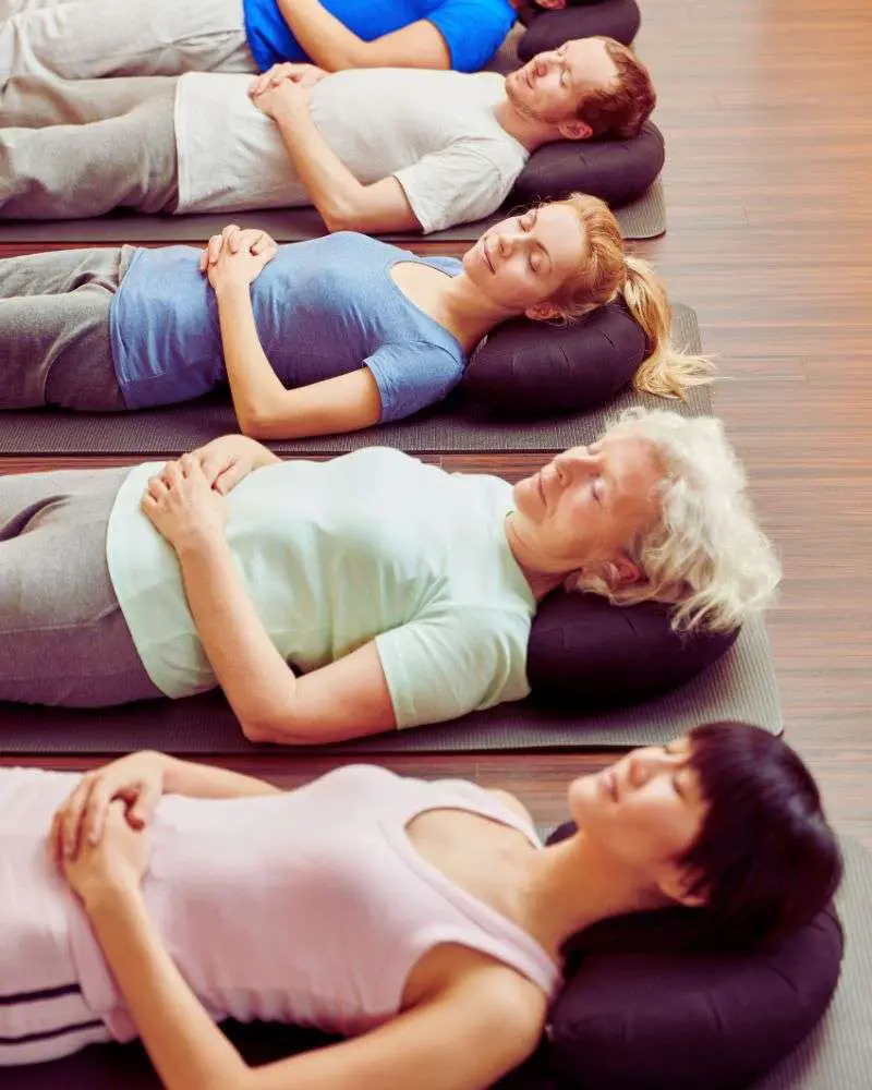 a group of people lying on mats