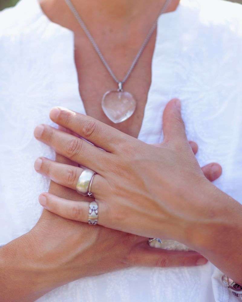 a close up of hands and necklaces on a spirtual coach who has learned how to be a life coach over 50